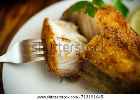 catfish roasted in batter on a wooden table