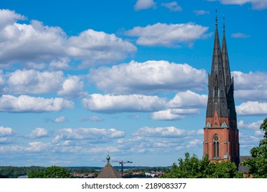 Cathedral Church Spire Against Blue Cloudy Sky In Uppsala, Sweden