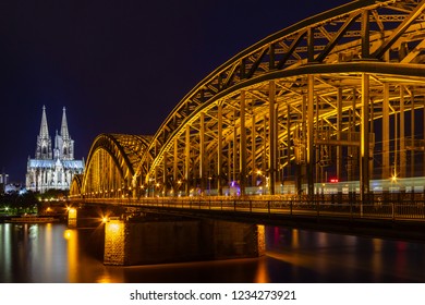 the cathedral from Cologne with the Hohenzollern bridge and the Rhine River at night, beautiful illumination