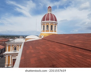 The Cathedral in Granada with red roofs around - Shutterstock ID 2311557619
