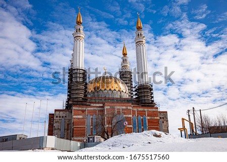 Cathedral Mosque Ar rahim. Construction of the Cathedral Mosque in the city of Ufa on Salavat Yulaev Avenue in winter time against a blue sky with clouds.