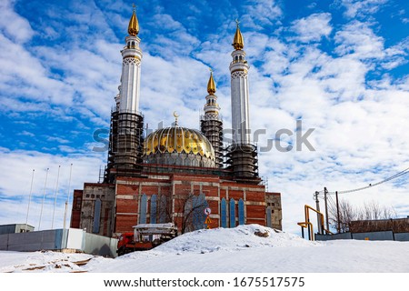 Cathedral Mosque Ar rahim. Construction of the Cathedral Mosque in the city of Ufa on Salavat Yulaev Avenue in winter time against a blue sky with clouds.