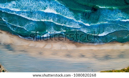 Aerial Drone View Of Blue Ocean Waves And Beautiful Sandy Beach Shore in Portugal