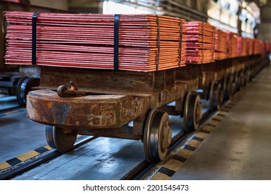 Cathode copper sheets on rail carriages in warehouse - Shutterstock ID 2201545473