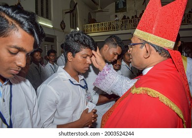 Catholic bishop is giving Confirmation sacrament. Location: Kerala, India Date 21-10-2019.