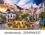 Catholic cathedral on square in the French village in Ba Na Hills Park in Da Nang in Vietnam at sunset