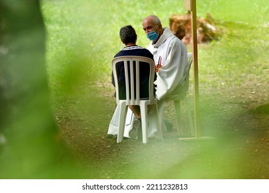 Catholic Church During Covid-19 Epidemic. A Penitent Confessing His Sins. Holy Confession. Sacrament Of Reconciliation.  Sanctuary Of La Benite Fontaine. France.  09-27-2020