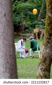 Catholic Church During Covid-19 Epidemic. A Penitent Confessing His Sins. Holy Confession. Sacrament Of Reconciliation.  Sanctuary Of La Benite Fontaine. France.  09-27-2020