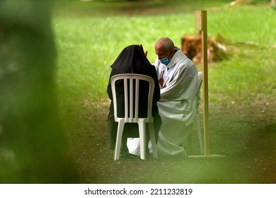 Catholic Church During Covid-19 Epidemic. A Penitent Confessing His Sins. Holy Confession. Sacrament Of Reconciliation.  Sanctuary Of La Benite Fontaine. France.  09-27-2020