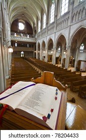 Catholic church interior, from the pulpit. Open Bible in foreground.