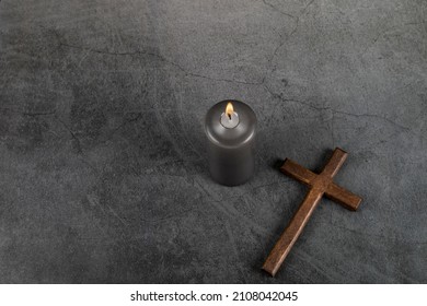 Catholic Cross with burning candle. Ash Wednesday, Lent season, Holy Week, Good Friday and Palm Sunday concept. Copy space.