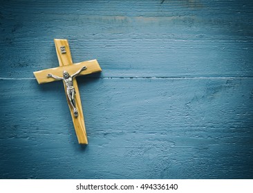 Catholic Cross On A Wooden Background