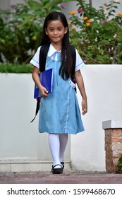 Catholic Diverse Female Student Standing Wearing School Uniform With Books