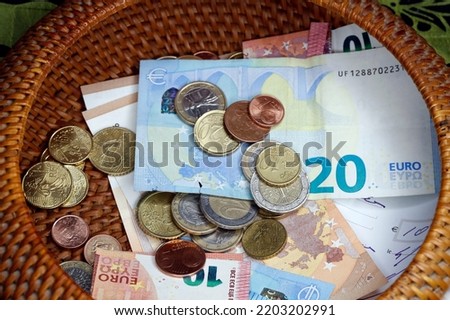 Catholic mass. Collection. Coins and banknotes in a basket. France. 