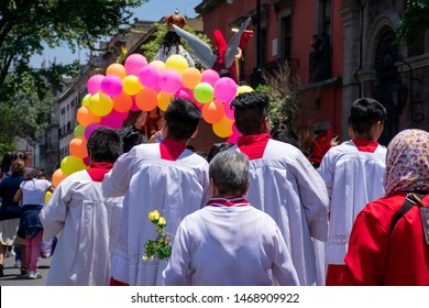 Catholic pilgrimage with acolytes or altar boys on a street in Mexico City