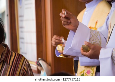 Catholic Priest Granting The Communion