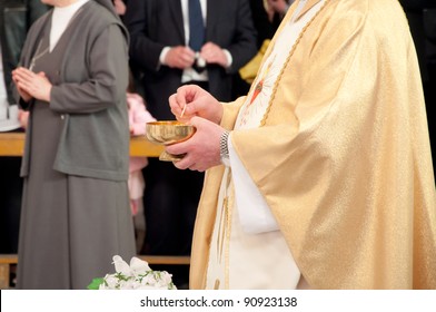 Catholic Priest Granting The Communion