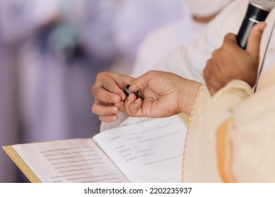 Catholic Priest Granting The Communion With Holy Book