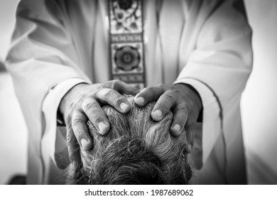 Catholic Priest hands giving the blessing after Confession. Sacraments of the Catholic Christian religion in church.