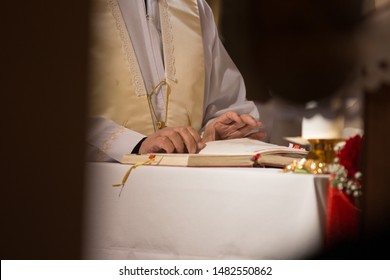 Catholic priest reading from a holy book during mass - Shutterstock ID 1482550862