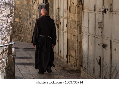 Catholic priest walking on the narrow stone street in the Old city of Jerusalem - Shutterstock ID 1503735914