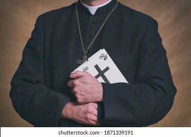 Catholic Priest's Hands Holding The Holy Bible