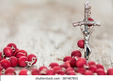 Catholic Rosary On Old Wooden  Background. Selective Focus.