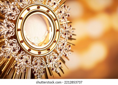 Catholic theme. Golden monstrance on bokeh background.