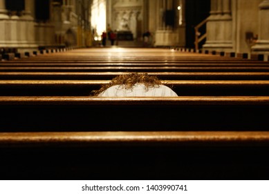 Catholic Woman Alone Praying Prostrate Inside A Christian Temple.