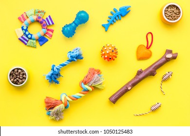 cats and dogs toys and acessories for pets yellow background top view