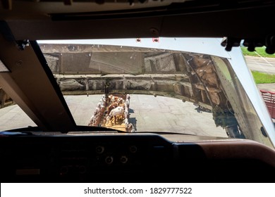 A Cattle Carrier And The Open Nose Cargo Door In Front Of The Cockpit Seen From The Pilot's Point Of View While Offloading Cows From A Jumbo Jet