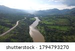 The Cauca River as it passes through Puente Inglesias to the southwest of Antioquia in Colombia. On its left side, the fourth generation road between Antioquia and the Colombian Coffee Region.