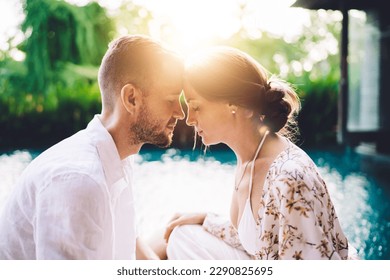 Caucaisan couple in love having holistic healing retreat for reunion togetherness during summer honeymoon at villa terrace, calm husband and wife meditate during teamwork therapy at yoga practice - Powered by Shutterstock