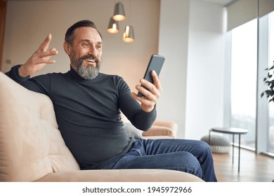 Caucasian Adult Man Is Sitting With Smartpone In Modern Cozy Office Lounge Zone