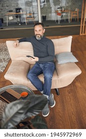 Caucasian Adult Man Is Sitting With Smartpone In Modern Cozy Office Lounge Zone