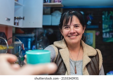 Caucasian Adult Woman At Home Smiling And Serving Cup Of Coffee To Guest, First Person Perspective, Lifestyle Concept.