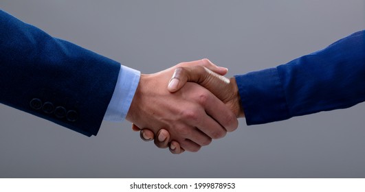 Caucasian And African American Business People Shaking Hands, Isolated On Grey Background. Business Technology, Communication And Growth Concept.