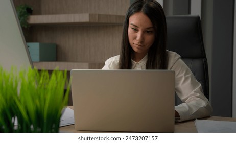 Caucasian analyst financial specialist busy business girl office worker manager entrepreneur female at workplace businesswoman woman writing notes working with computer paperwork documents laptop work - Powered by Shutterstock