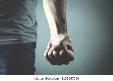 Caucasian angry and aggressive man threatening with fist. - Shutterstock ID 1151347034