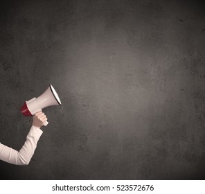 Caucasian Arm Holding Megaphone With Plain Grunge Background