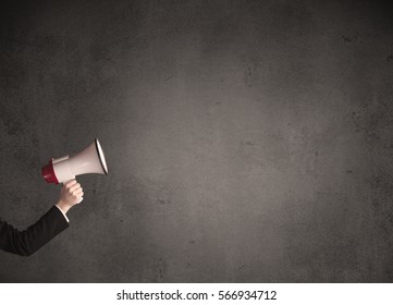 Caucasian Arm Holding Megaphone With Plain Grunge Background