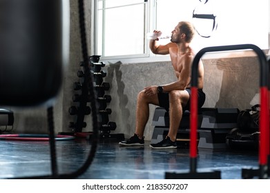 Caucasian Athlete Man Person Drink A Bottle Of Fresh Water After Workout In Sport Gym, Adult Male Exercise In Fitness For Building Strong Body, Take A Break Of Muscular Healthy Training Lifestyle