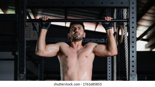 Caucasian Athletics Man Pull Up Exercise On High Bar In Gym And Fitness Club