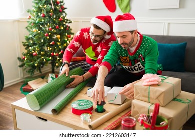 Caucasian Attractive Gay Men With Santa Hats Wrapping Christmas Gifts For Their Family And Friends