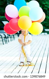 Caucasian Baby Boy Palys With Baloons In Park