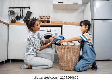 Caucasian beautiful mother teaching young daughter wash dirty clothes. Adorable little cute girl child help and learn from parent mom to put laundry in washer appliance at home. Domestic-Housekeeping. - Shutterstock ID 2279544833