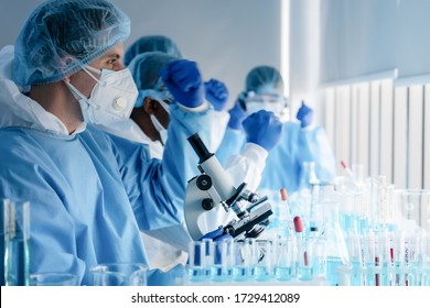 caucasian biological research scientist and team working together in vaccine development laboratory to develop coronavirus covid-19 vaccine, selective focused - Shutterstock ID 1729412089