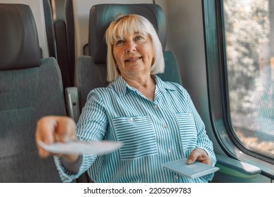 Caucasian Blonde Senior Female Tourist Showing Ticket To Checking Conductor In Modern High Speed Train