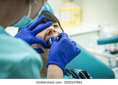 Caucasian boy with brown hair at the dentist's office putting an alginate mold for dental impressions - Powered by Shutterstock