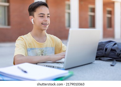 Caucasian boy high school student working with laptop computer outdoors. Secondary education. - Powered by Shutterstock